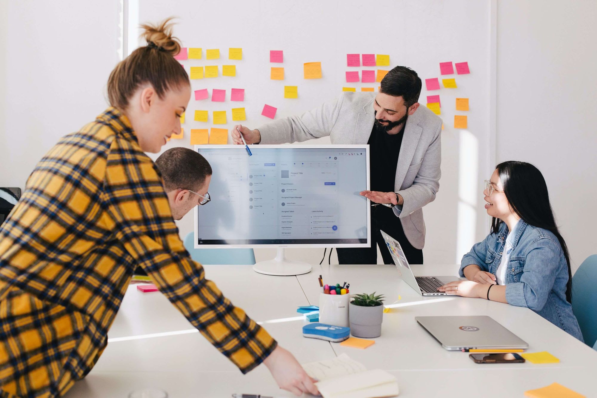 Marketing meeting with whiteboard and computer