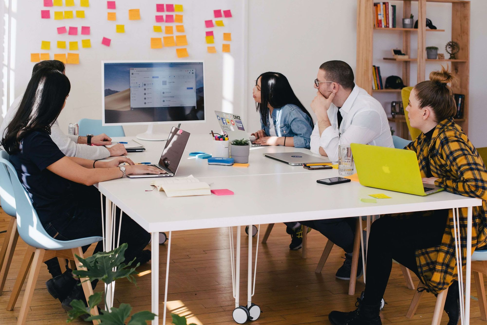 Employees looking at a problem on whiteboard