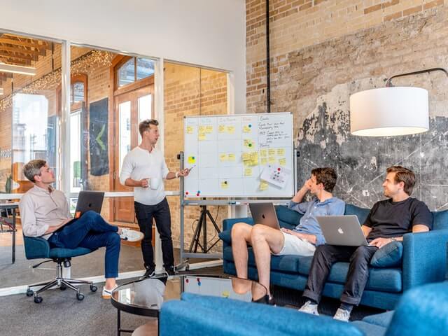 businesses meeting on sofa with whiteboard